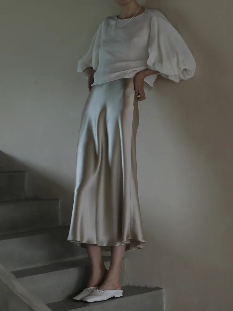 Elegant Korean-style skirt paired with statement earrings and a clutch.