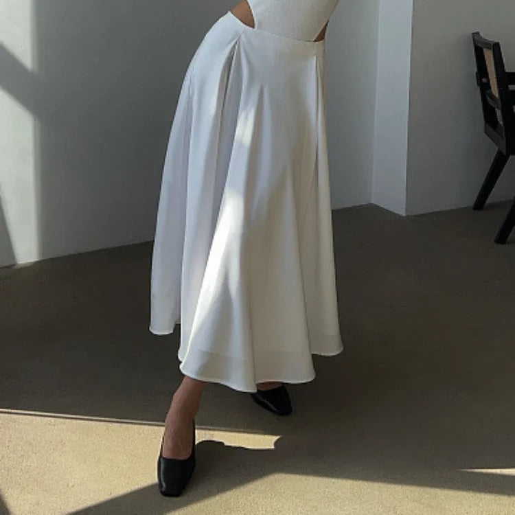 Flowy satin skirt in a vibrant autumn setting.