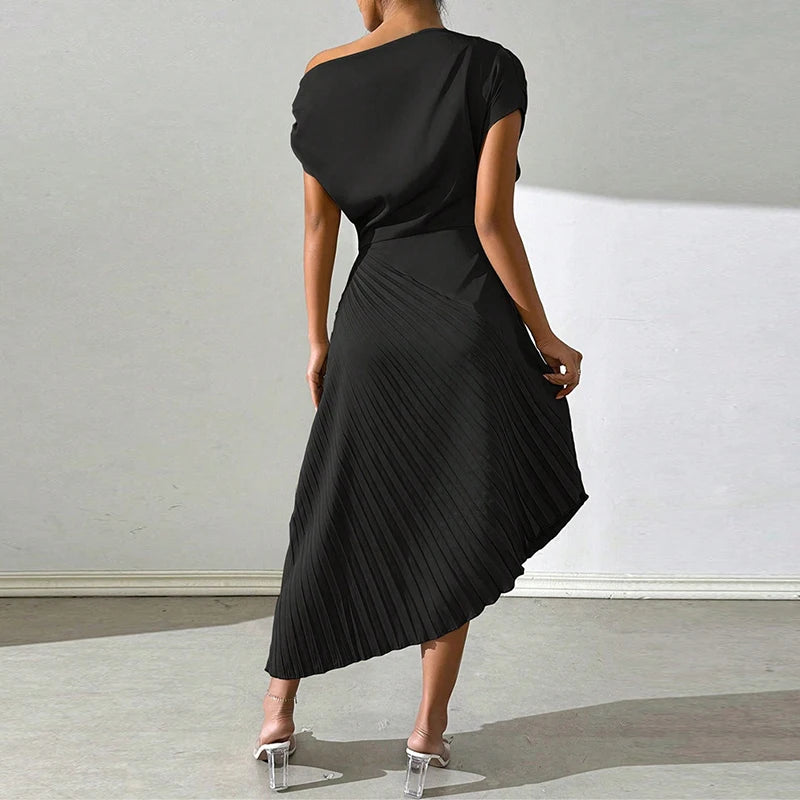 Model adjusting dress with hand in a studio