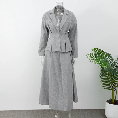 Long woolen skirt suit paired with ankle boots and a scarf
