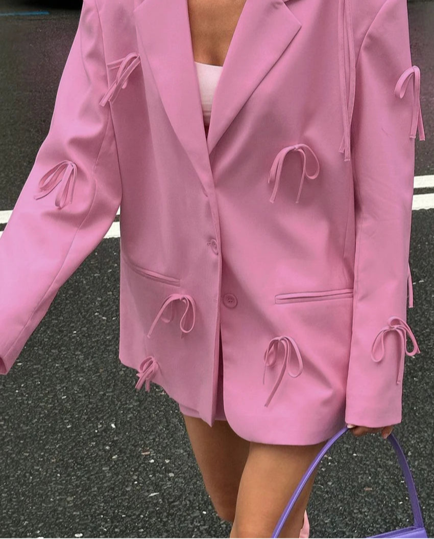 Elegant pink jacket with long sleeves on a mannequin
