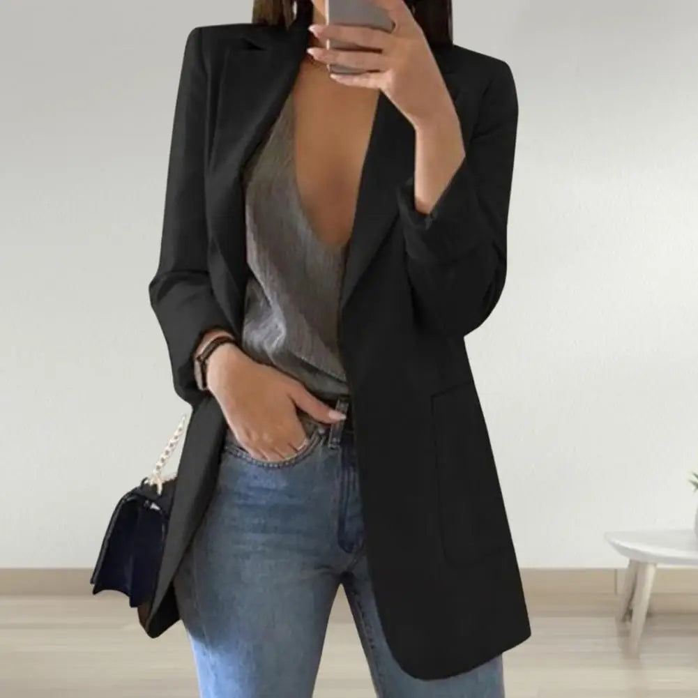 Front view of a women's long sleeve blazer with button details.