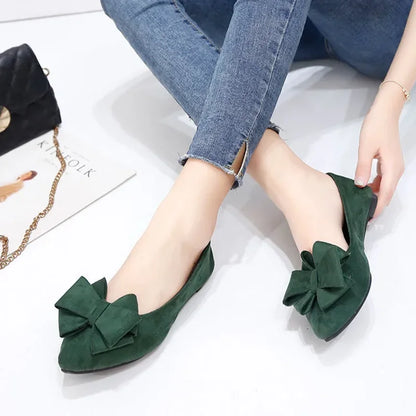 Close-up view of Green Bow Tie Flock Flat Shoes.