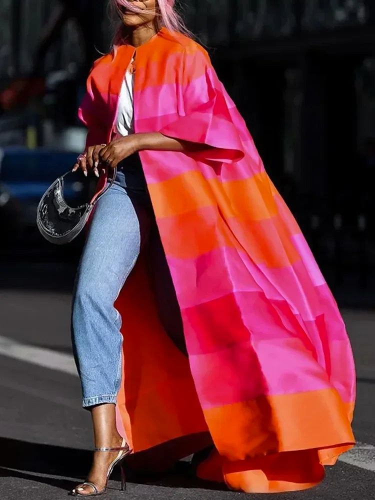 Model wearing striped trench coat with belt
