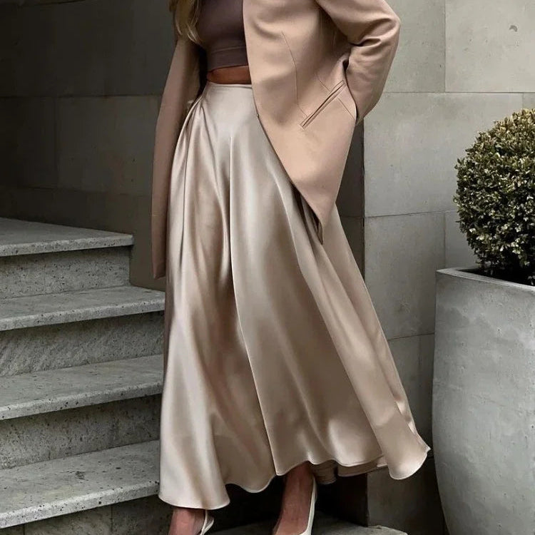 Elegant autumn satin skirt on a mannequin.
