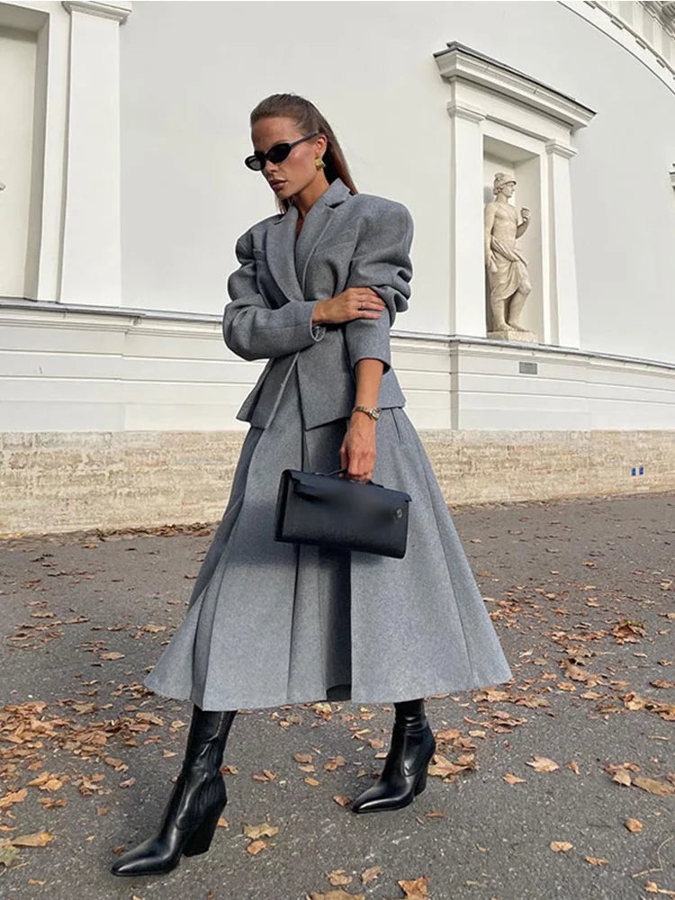 Model wearing a long woolen skirt suit with a turtleneck sweater