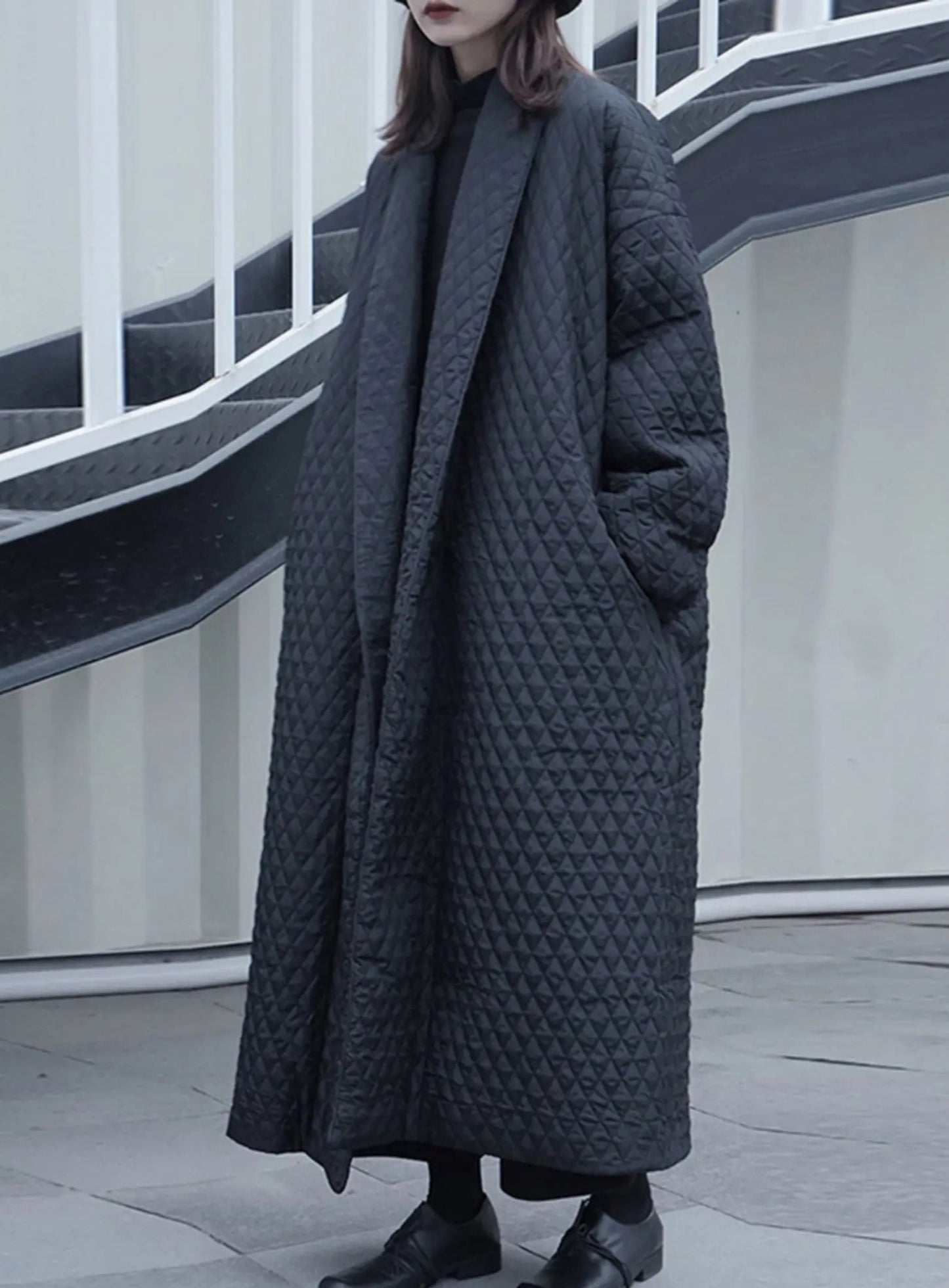 Model showcasing the breathable fabric of the cotton coat.