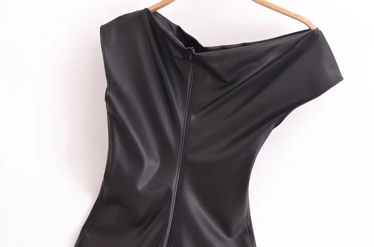 Black faux leather dress with draped detailing on hips.
