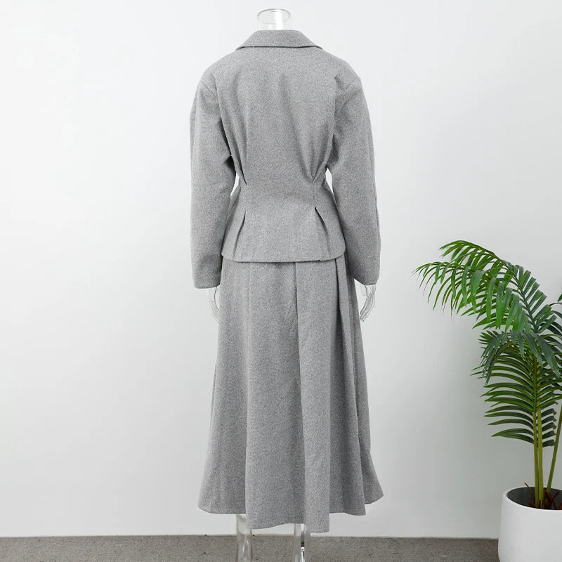 Long woolen skirt suit in cream displayed with a wool scarf
