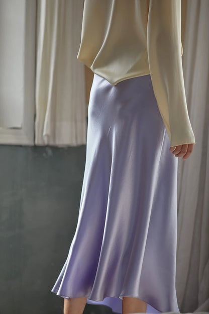 Elegant skirt in a pastel shade photographed outdoors.
